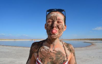 crazy-sexy-fun-traveler-showing-the-tongue-off-covered-all-with-mud