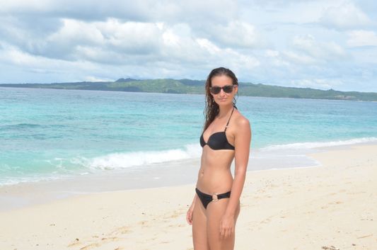 crazy sexy fun traveler on deserted Pudsa beach on Boracay