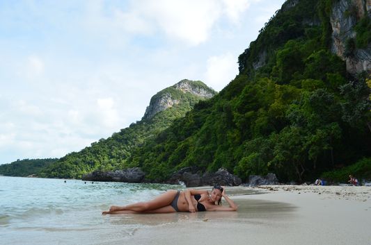 crazy sexy fun traveler relaxing on Koh Wua Talap beach in Angthong National Park