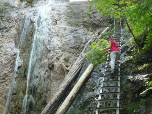climbing up the waterfall in Slovensky raj in Slovakia