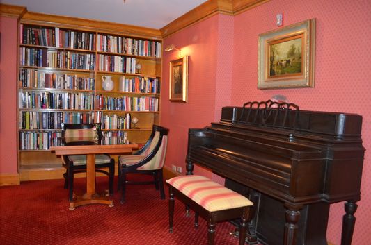 piano and books in Club room in Elysee hotel