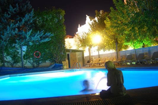 Crazy sexy fun traveler swimming in Balneri Prats warm pool