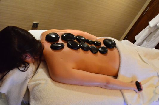 crazy sexy fun traveler getting a hot stone massage in Sheraton Bratislava