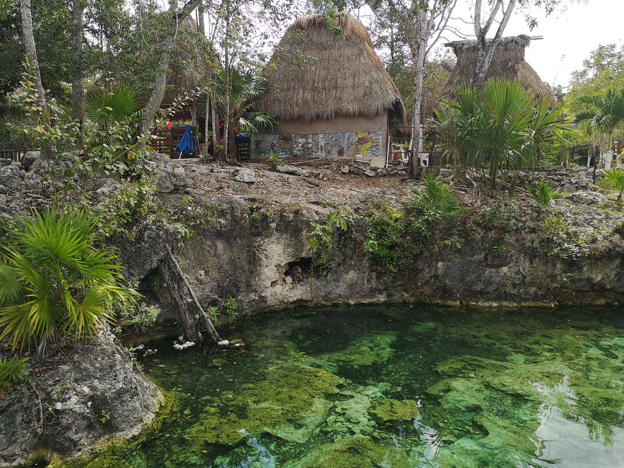 cenote Santa Cruz Tulum with a house behind