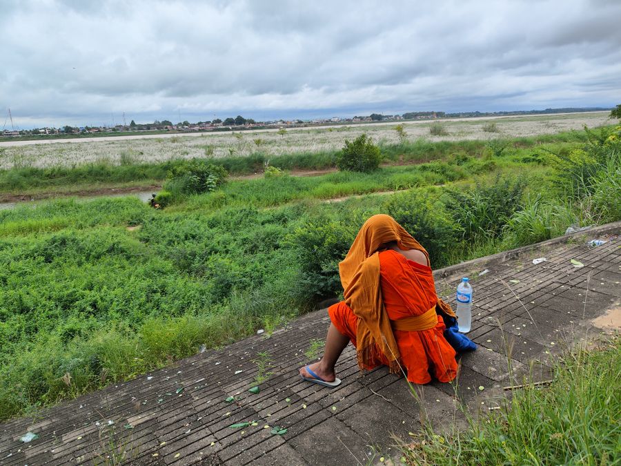 a monk by the Mekong river Vientiane Laos