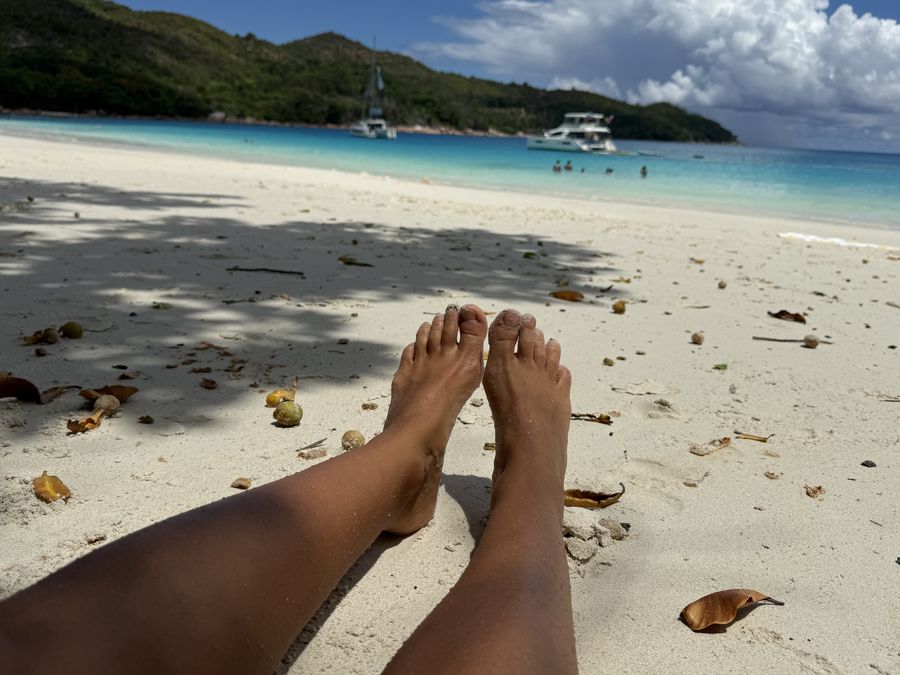 relaxing on beach Anse Lazio Praslin Seychelles